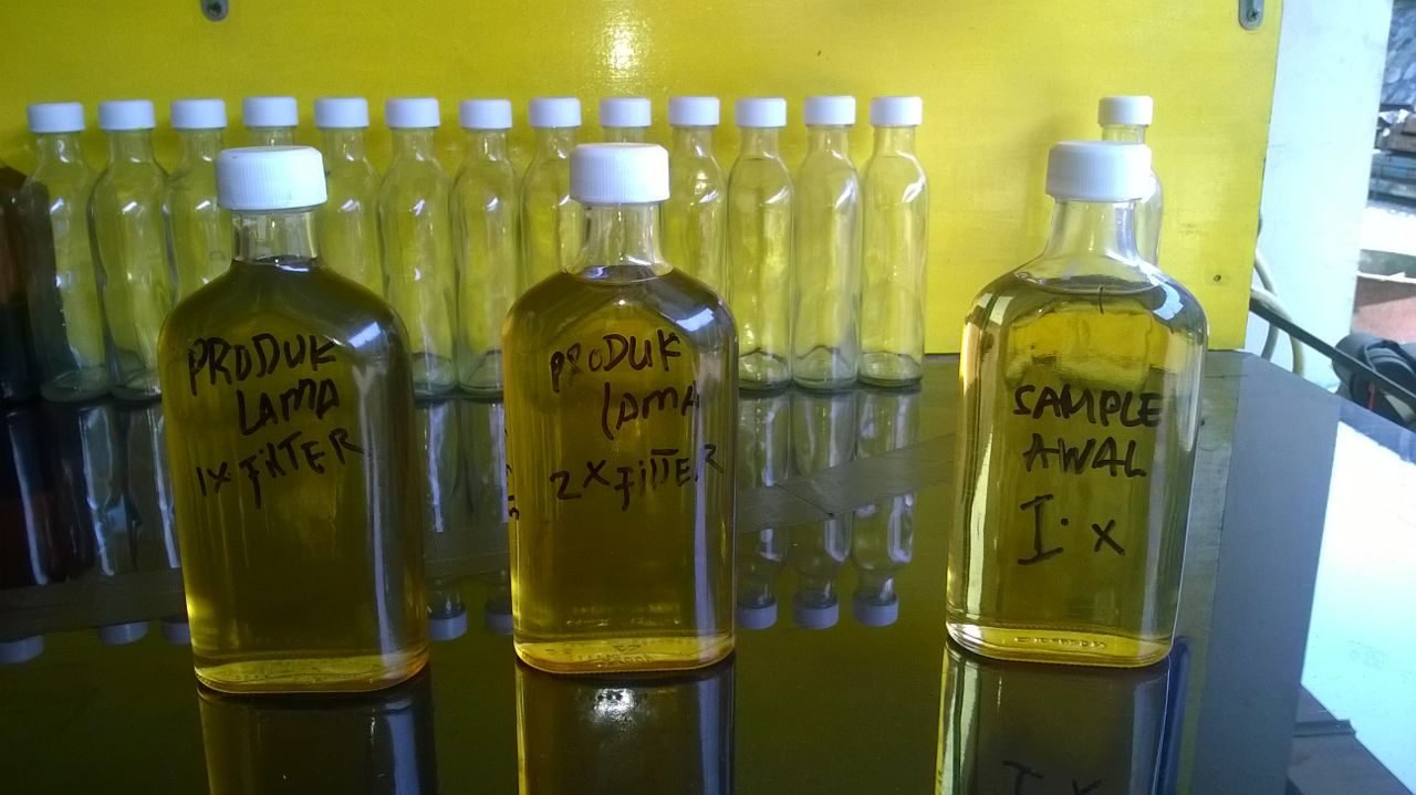 Row of bottles holding golden diesel samples taken at different processing stages