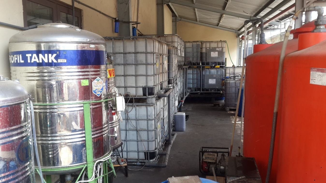 Row of stainless and plastic tanks at the Semarang diesel plant